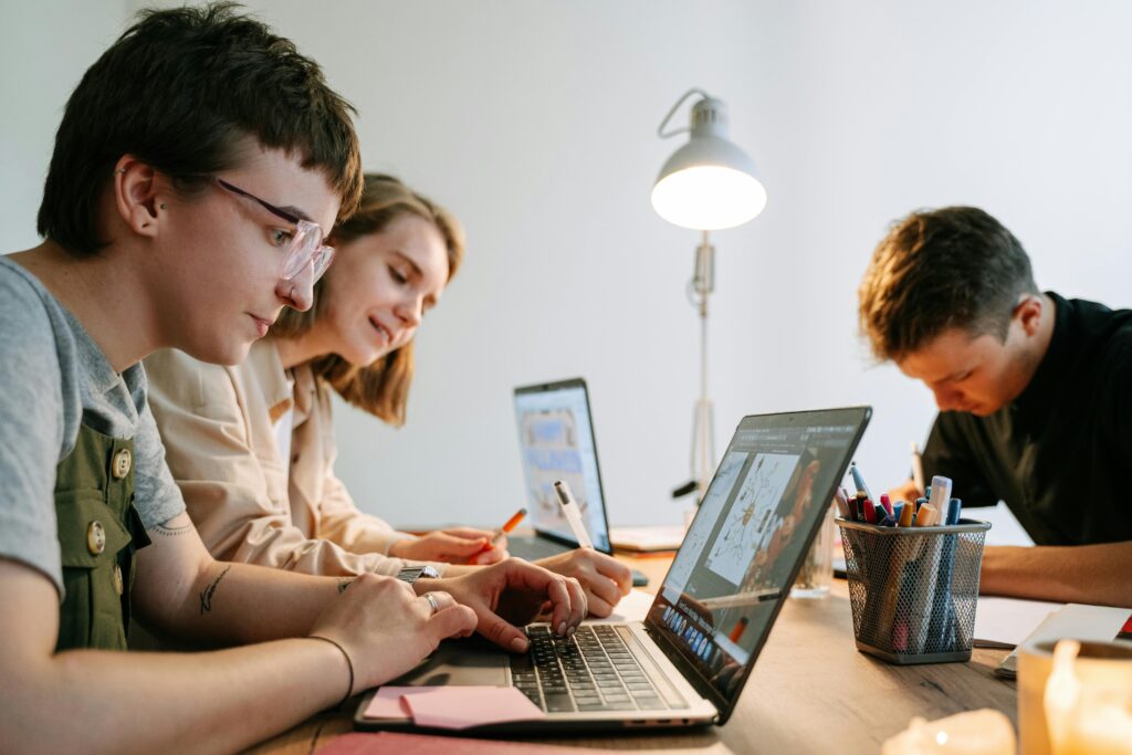 Young creative professionals collaborating on a project in a modern workspace. Perfect teamwork depiction.